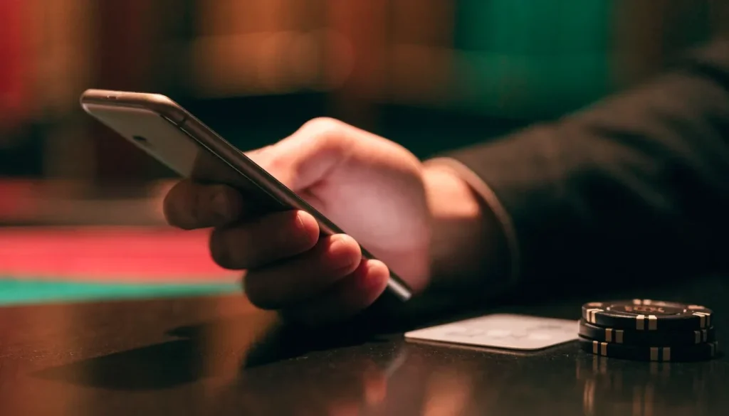 Small casino deposit chips beside a phone in a UK setting